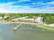 Aerial view of waterfront community with a pier and lush landscaping at 650 Pinellas Point S Dr # 128, St Petersburg, FL 33705