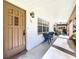 Condo entry with private patio and seating for two at 650 Pinellas Point S Dr # 128, St Petersburg, FL 33705