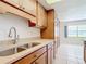 Kitchen with stainless steel sink and wood cabinets at 650 Pinellas Point S Dr # 128, St Petersburg, FL 33705