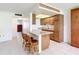 View of kitchen with wood cabinets and breakfast bar at 650 Pinellas Point S Dr # 128, St Petersburg, FL 33705