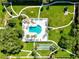 Community pool with surrounding lounge chairs and lush landscaping at 650 Pinellas Point S Dr # 128, St Petersburg, FL 33705