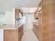Bright kitchen with light wood cabinets and modern appliances at 650 Pinellas Point S Dr # 128, St Petersburg, FL 33705