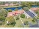 A serene aerial view shows the condo with a tile roof, adjacent to a tranquil lake and convenient parking at 9543 86Th Ave # 9543, Seminole, FL 33777