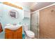 This bathroom features a wood vanity, modern sink, and a glass shower with decorative tiles at 9543 86Th Ave # 9543, Seminole, FL 33777