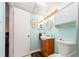 This bathroom features a modern sink with wood vanity and round mirror above at 9543 86Th Ave # 9543, Seminole, FL 33777
