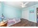 This bedroom features a large double closet, ceiling fan, and hardwood floors at 9543 86Th Ave # 9543, Seminole, FL 33777