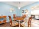 Cozy dining area with a round table, light blue walls, and wood floors adjacent to the kitchen at 9543 86Th Ave # 9543, Seminole, FL 33777