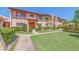 A beautiful condo with a well-manicured lawn, trimmed hedges, palms, and a cozy porch at 9543 86Th Ave # 9543, Seminole, FL 33777