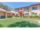 Inviting condo with well-kept lawn, colorful flowers, green shrubbery, and lush palm trees at 9543 86Th Ave # 9543, Seminole, FL 33777