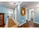 Bright hallway with blue walls, stylish decor, and access to a bathroom and the front entrance at 9543 86Th Ave # 9543, Seminole, FL 33777