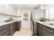 Charming kitchen with stainless steel refrigerator and appliances, light countertops, and tiled floors at 9543 86Th Ave # 9543, Seminole, FL 33777