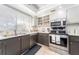 Well-lit kitchen featuring stainless steel appliances, a double sink, and window with blinds for natural light at 9543 86Th Ave # 9543, Seminole, FL 33777