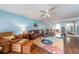 Inviting living room with blue walls, wood floors, and an open layout connecting to the dining area at 9543 86Th Ave # 9543, Seminole, FL 33777