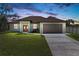 A charming ranch-style home with a two-car garage and manicured lawn at 756 Bowman Ter, Port Charlotte, FL 33953