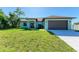 Single-story house with a two-car garage and well-maintained lawn at 756 Bowman Ter, Port Charlotte, FL 33953