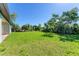 Expansive grassy backyard with mature trees and landscaping at 756 Bowman Ter, Port Charlotte, FL 33953