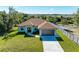 Single-Gathering home with brown roof, light-colored siding and a two-car garage at 756 Bowman Ter, Port Charlotte, FL 33953