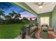 Relaxing covered patio with seating area and backyard view at 756 Bowman Ter, Port Charlotte, FL 33953