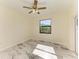 Bright bedroom with ceiling fan and marble-look tile floor at 756 Bowman Ter, Port Charlotte, FL 33953