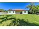House with large backyard featuring a grassy lawn at 756 Bowman Ter, Port Charlotte, FL 33953