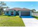 Newly built home with a two-car garage and a large front yard at 756 Bowman Ter, Port Charlotte, FL 33953