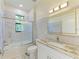 Bathroom with marble-look vanity and shower/tub combo at 756 Bowman Ter, Port Charlotte, FL 33953