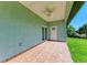 Covered back patio with tile flooring, ceiling fan, and sliding glass doors at 756 Bowman Ter, Port Charlotte, FL 33953