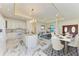 Open concept kitchen and dining area with marble floors and white cabinets at 756 Bowman Ter, Port Charlotte, FL 33953