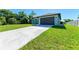 Newly built home with a long driveway and green lawn at 756 Bowman Ter, Port Charlotte, FL 33953