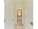 View down hallway to a bright bathroom with marble floors at 756 Bowman Ter, Port Charlotte, FL 33953