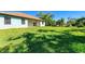 Large backyard with lush green grass and a home in the background at 756 Bowman Ter, Port Charlotte, FL 33953