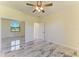 Bedroom with mirrored closet doors and marble-look floors at 756 Bowman Ter, Port Charlotte, FL 33953