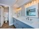 Bathroom with double vanity, updated fixtures, and large mirror at 550 Johns Pass Ave, Madeira Beach, FL 33708