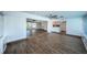 Bright sunroom features hardwood floors and views into the living area and kitchen at 550 Johns Pass Ave, Madeira Beach, FL 33708