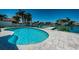 Inviting kidney-shaped pool with large patio and canal views at 550 Johns Pass Ave, Madeira Beach, FL 33708
