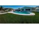 Relaxing kidney-shaped pool surrounded by lush grass at 550 Johns Pass Ave, Madeira Beach, FL 33708