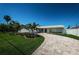Beautiful home with a landscaped yard and paved driveway at 550 Johns Pass Ave, Madeira Beach, FL 33708