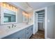 Modern bathroom with double vanity and walk-in closet at 550 Johns Pass Ave, Madeira Beach, FL 33708