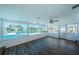 Sunroom with water views and dark brown wood floors at 550 Johns Pass Ave, Madeira Beach, FL 33708