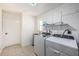 Laundry room with washer, dryer, and utility sink at 550 Johns Pass Ave, Madeira Beach, FL 33708