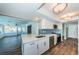 Modern kitchen with white cabinets, quartz countertops, and stainless steel appliances at 550 Johns Pass Ave, Madeira Beach, FL 33708