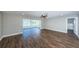 Bright living room featuring hardwood floors and access to a sunroom at 550 Johns Pass Ave, Madeira Beach, FL 33708