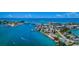 Wide aerial showcasing the waterfront, bridge, and town at 550 Johns Pass Ave, Madeira Beach, FL 33708