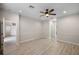 Spacious bedroom with wood-look floors and access to bathroom at 2622 Yukon Cliff Dr, Ruskin, FL 33570