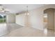 Bright dining area with adjacent bathroom and laminate floors at 2622 Yukon Cliff Dr, Ruskin, FL 33570