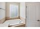 Bathroom with soaking tub and glass block window at 2622 Yukon Cliff Dr, Ruskin, FL 33570