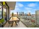 Balcony with outdoor dining set and panoramic city skyline views at sunset at 1000 Water St # 1703, Tampa, FL 33602