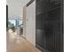 Hallway with a modern barn door leading to a living area with a kitchen and city views at 1000 Water St # 1703, Tampa, FL 33602