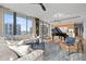 Bright living room with a piano, sleek furniture, and large windows offering city views at 1000 Water St # 1703, Tampa, FL 33602
