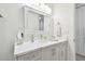 Bathroom vanity with marble countertop, decorative mirror and lighting at 400 150Th Ave # 301, Madeira Beach, FL 33708